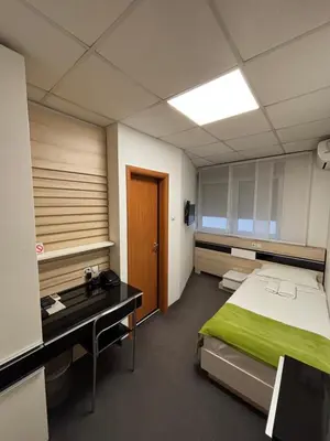 a room with a bed and a desk in it at Garni Hotel Consul in Niš