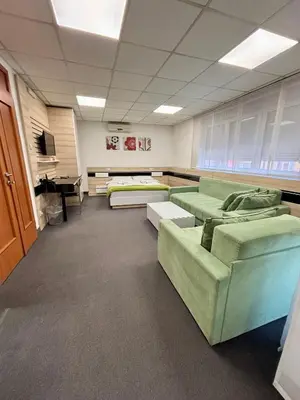 a large room with couches and tables in it at Garni Hotel Consul in Niš