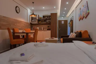 a living room with a table and a dining room at Milmari Premier 15 in Kopaonik