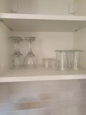 four glass dishes sitting on a shelf in a kitchen at Vila Vrh in Crni Vrh