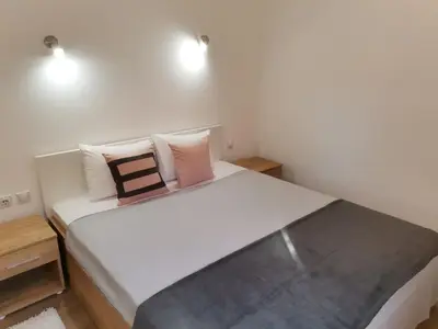 a bedroom with a large white bed with two pillows at Vila Vrh in Crni Vrh