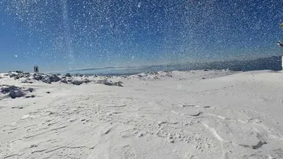 a snow covered hill with footprints in the snow at Vila Treska 98 in Kopaonik