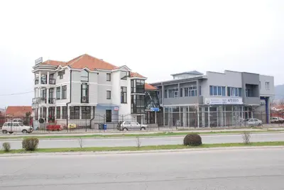 a row of houses on the side of a road at M Garni Hotel in Vranje