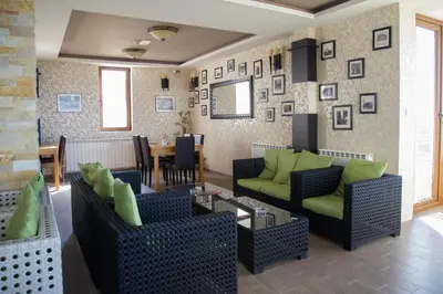 a living room with two couches and a table at Apartman Nena b15 in Kopaonik