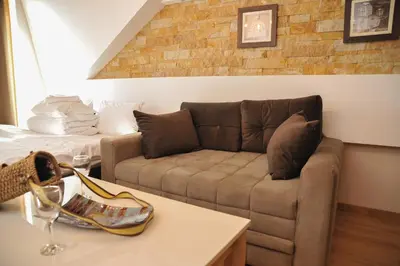 a living room with a couch and a bed at Apartman Nena b15 in Kopaonik