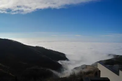 a view of a valley of clouds in the mountains at Apartman Nena b15 in Kopaonik