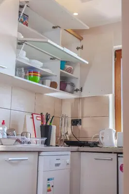 a kitchen with white cabinets and a counter top at Snow Oasis Kopaonik in Kopaonik