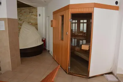 a wooden cabinet in a room with a tub at Snow Oasis Kopaonik in Kopaonik