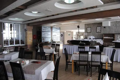 a dining room with tables and chairs and a restaurant at Snow Oasis Kopaonik in Kopaonik