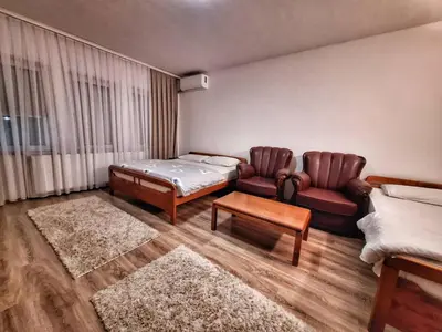 a room with a bed and a couch and a table at Evropa in Gračanica
