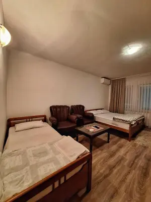 a living room with two beds and a couch at Evropa in Gračanica