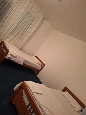 two bunk beds in a room with a window at Evropa in Gračanica