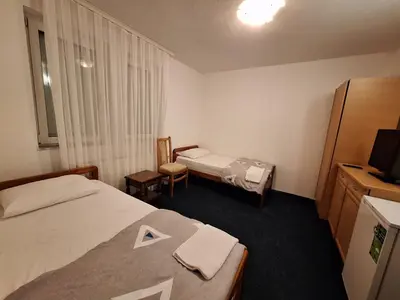 a hotel room with two beds and a television at Evropa in Gračanica