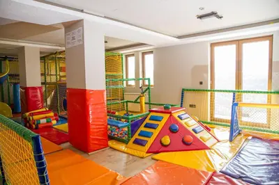 a childrens play room with a playground with a slide at Milmari Apartment 43 Premier Pollo in Kopaonik