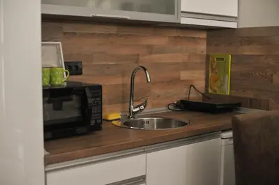 a kitchen with a sink and a microwave at As Lux Apartmani Kopaonik in Kopaonik
