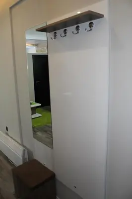 a door with a mirror in a room at As Lux Apartmani Kopaonik in Kopaonik