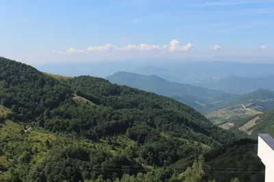 a view of a valley of green mountains at As Lux Apartmani Kopaonik in Kopaonik