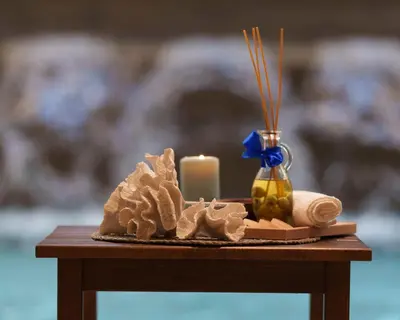 a small table with a candle and towels and a candle at Hotel Fontana Vrnjačka Banja in Vrnjačka Banja