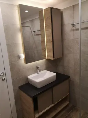 a bathroom with a sink and a mirror at Milmari Resort Premier 46 in Kopaonik