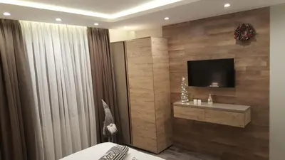a bedroom with a bed and a tv on a wall at Milmari Resort Premier 46 in Kopaonik