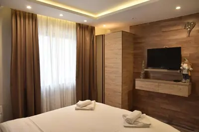 a hotel room with a bed and a television at Milmari Resort Premier 46 in Kopaonik