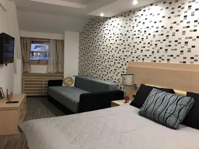 a hotel room with a bed and a couch at Apartmani Air in Kopaonik