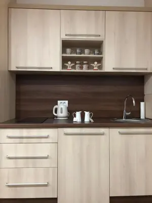 a kitchen with white cabinets and a sink at Apartmani Air in Kopaonik