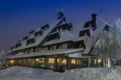 a building covered in snow at night at Apartmani Air in Kopaonik