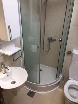 a bathroom with a shower and a toilet and a sink at YelaYeti Apartments in Kopaonik