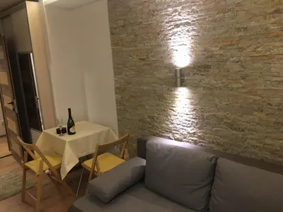 a living room with a couch and a table with a lamp at YelaYeti Apartments in Kopaonik
