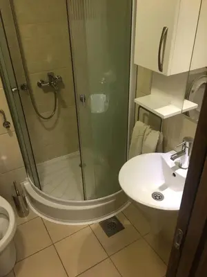 a bathroom with a shower and a sink and a toilet at YelaYeti Apartments in Kopaonik