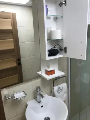 a bathroom with a white sink and a mirror at YelaYeti Apartments in Kopaonik