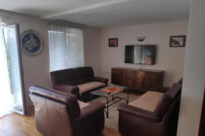 a living room with leather chairs and a flat screen tv at Allegro dream in Vranje
