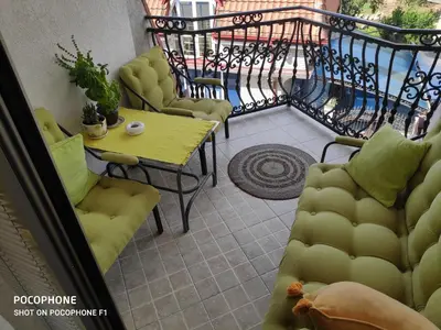 a balcony with a table and chairs on a balcony at Allegro dream in Vranje