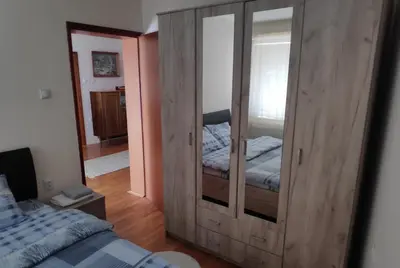 a bedroom with a large wooden cabinet with a bed at Allegro dream in Vranje