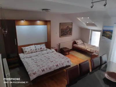 a bedroom with a large bed and a couch at Allegro dream in Vranje