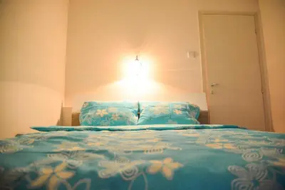 a bedroom with a bed with a light on the wall at Allegro dream in Vranje