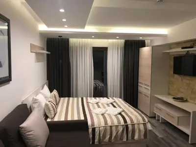 a bedroom with a bed and a television in it at Milmari Resort in Kopaonik