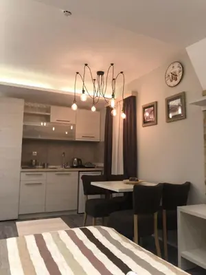 a kitchen and dining room with a table and chairs at Milmari Resort in Kopaonik