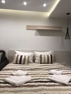 a bedroom with a large bed with pillows on it at Milmari Resort in Kopaonik