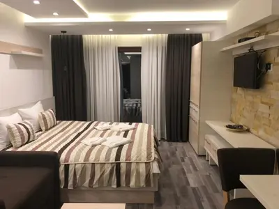 a hotel room with a bed and a couch at Milmari Resort in Kopaonik