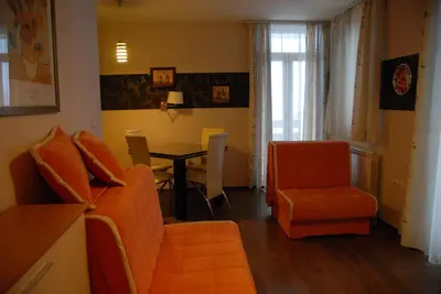 a living room with a couch and a table and chairs at Villa Milmari in Kopaonik