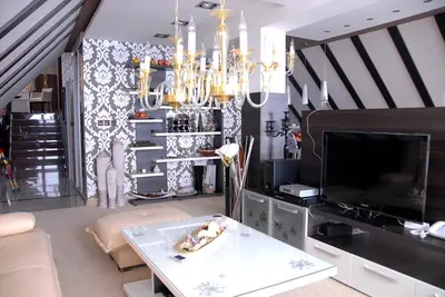 a living room with a chandelier and a table at Villa Milmari in Kopaonik