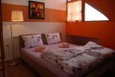 a bedroom with a bed with two towels on it at Villa Milmari in Kopaonik