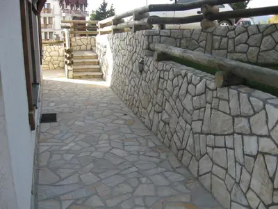 a stone wall with a stone walkway at Villa Sofija in Kopaonik