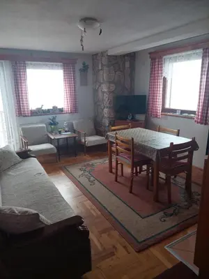 a living room with a table and chairs at Villa Sofija in Kopaonik