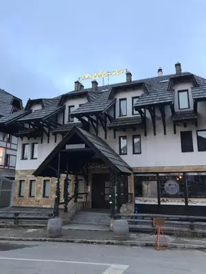a building with a gambrel roof on top of it at Višnja apartment in Kopaonik