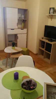 a living room with a table with a bowl of food on it at GOski Apartman Brzeće Kopaonik in Brzeće