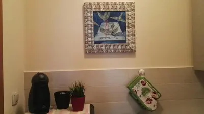 a counter top with a plant and a picture on the wall at GOski Apartman Brzeće Kopaonik in Brzeće