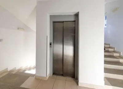 a hallway with a door and stairs in a building at GOski Apartman Brzeće Kopaonik in Brzeće